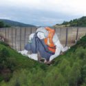 Ella et Pitr paint giant migrant on abandoned dam in Loire, France